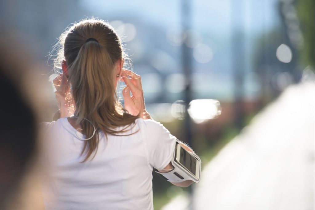 A runner carrying a phone on a run