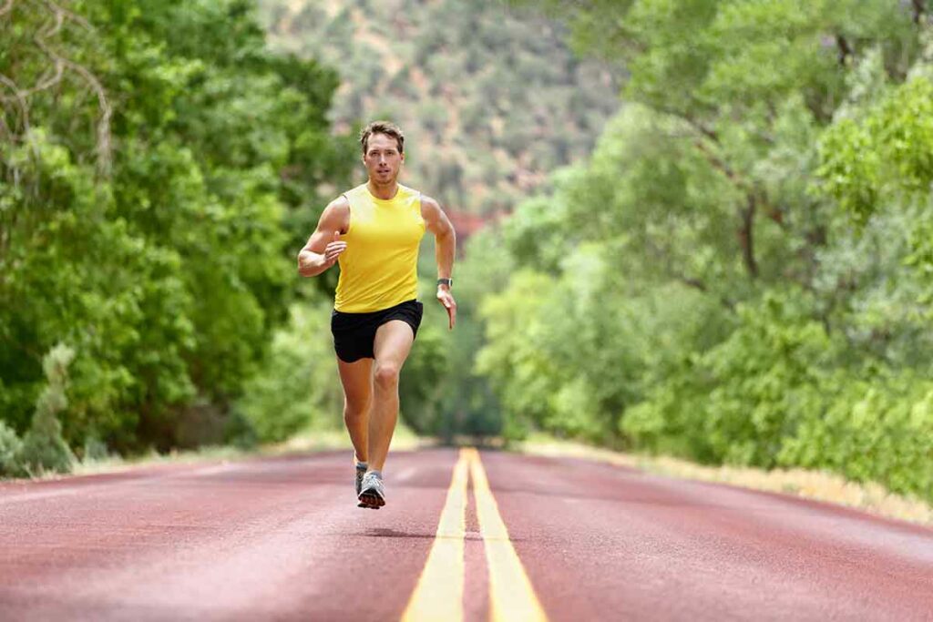 Runner doing interval training on a road